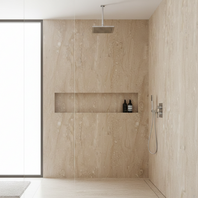 Modern shower with beige marble walls and a glass enclosure.