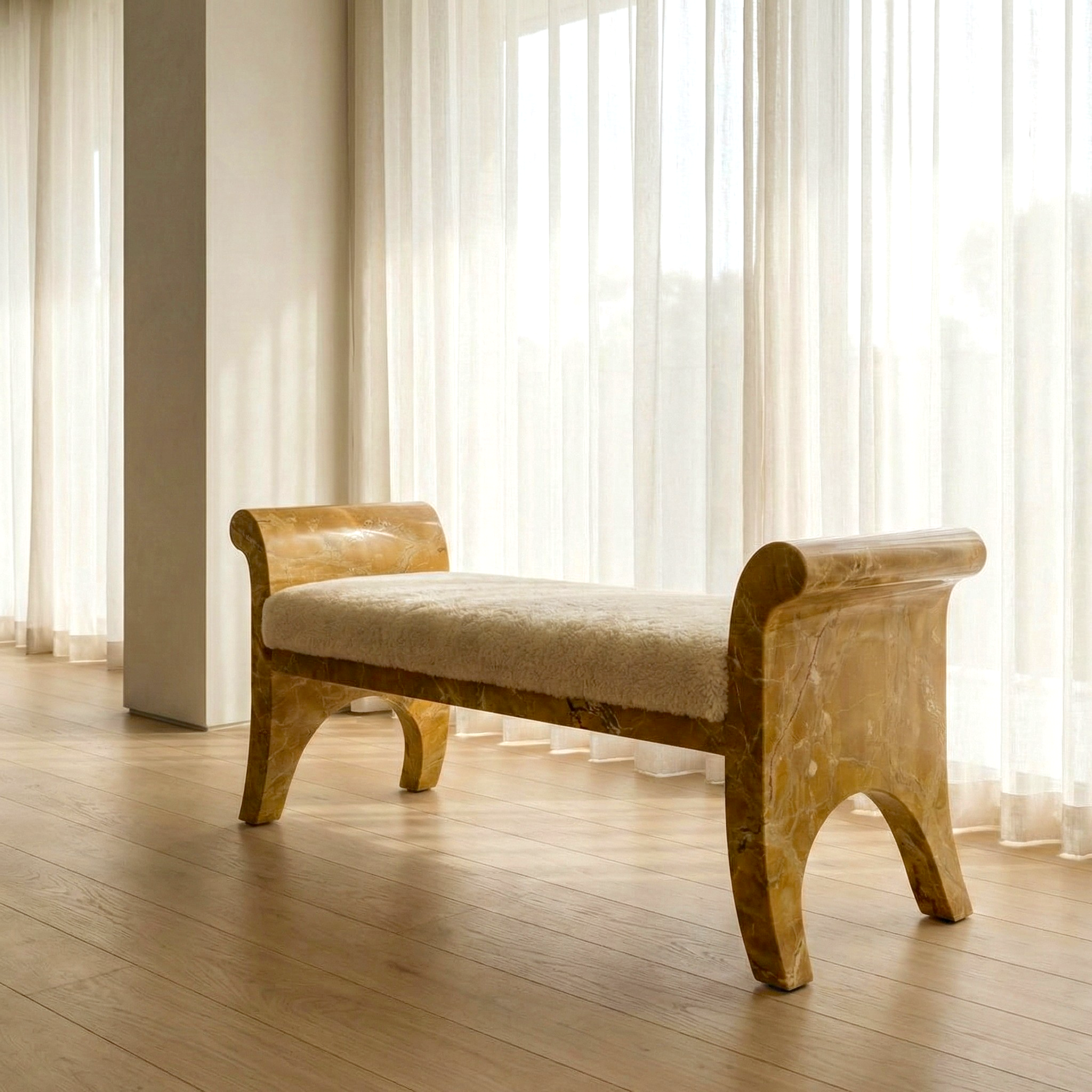 Marble bench with beige cushion in a room with large windows and light curtains.