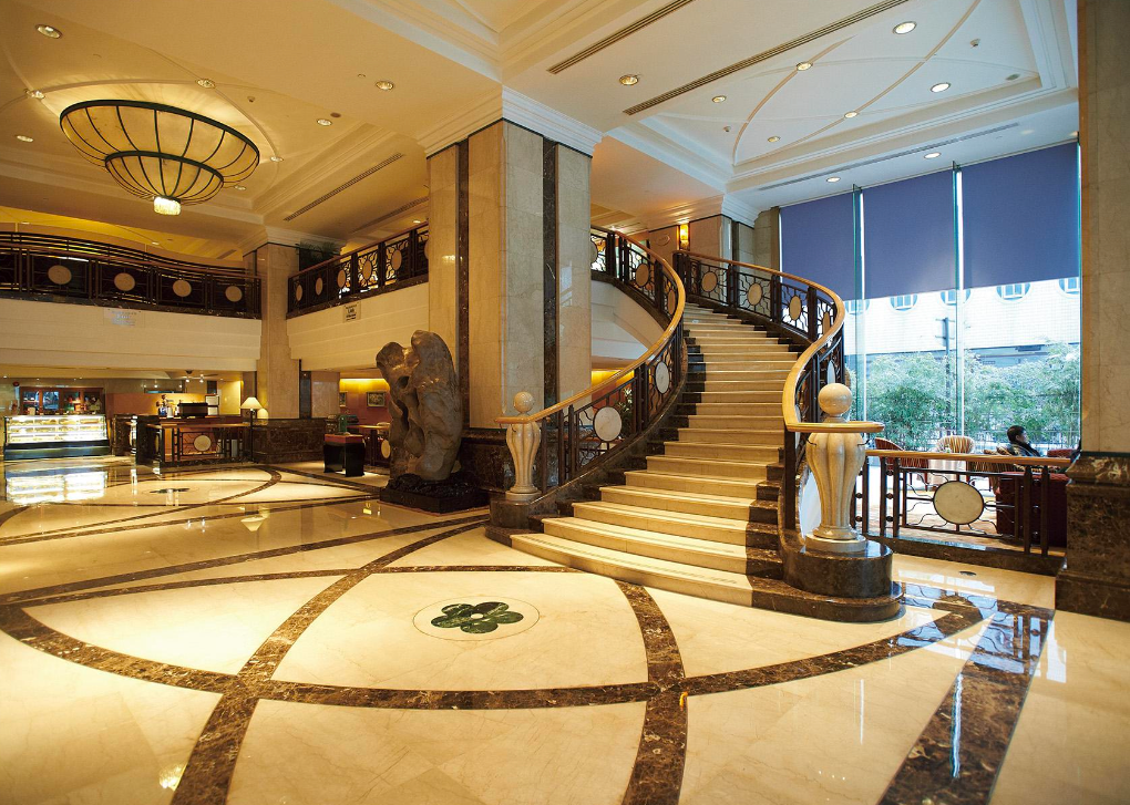 Luxurious hotel lobby with marble staircase and decorative elements